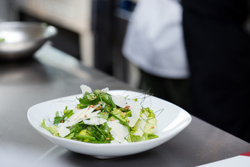 Fresh green herb salad with parmesan cheese.