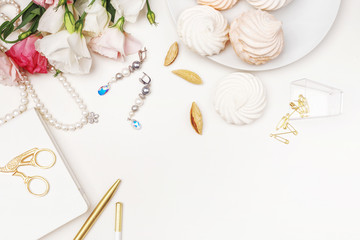 Beauty blog background. Gold style feminine accessories. Golden tinsel, scissors, pen, rings, necklace, bracelet , flowers and sweety on light background. Flat lay, top view