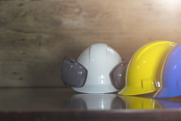 Fototapeta premium Engineer, electrician and worker 's helmet color as White, Blue and Yellow , PPE (Personal Protective Equipment) very importance for health protection. Safety at work concept