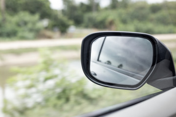 Side Mirror a car, reflection of traffic flow in left side rear view mirror 