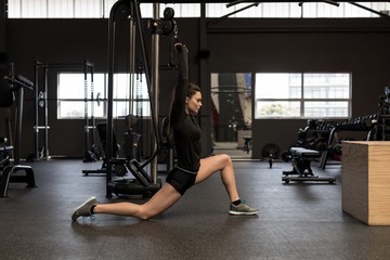 Young woman exercising in gym