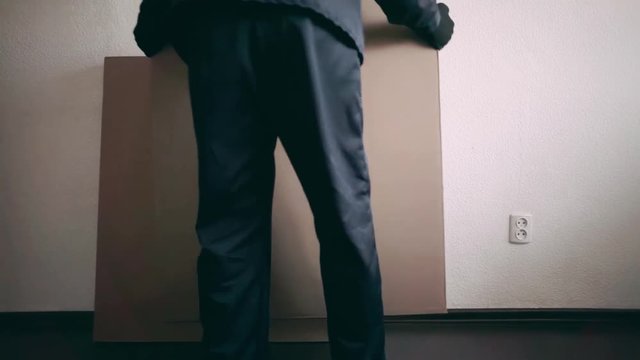 the furniture collector puts the second box with furniture near the wall