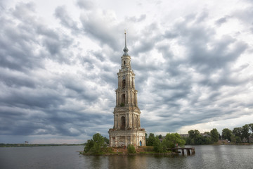 Flooded bell tower of St. Nicholas Cathedral in Kalyazin before the rain . Russia