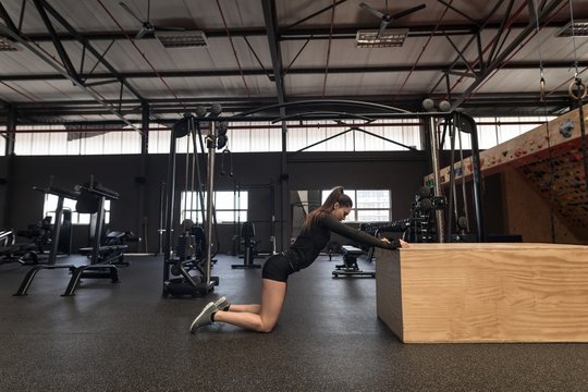 Woman doing stretching exercise in fitness studio