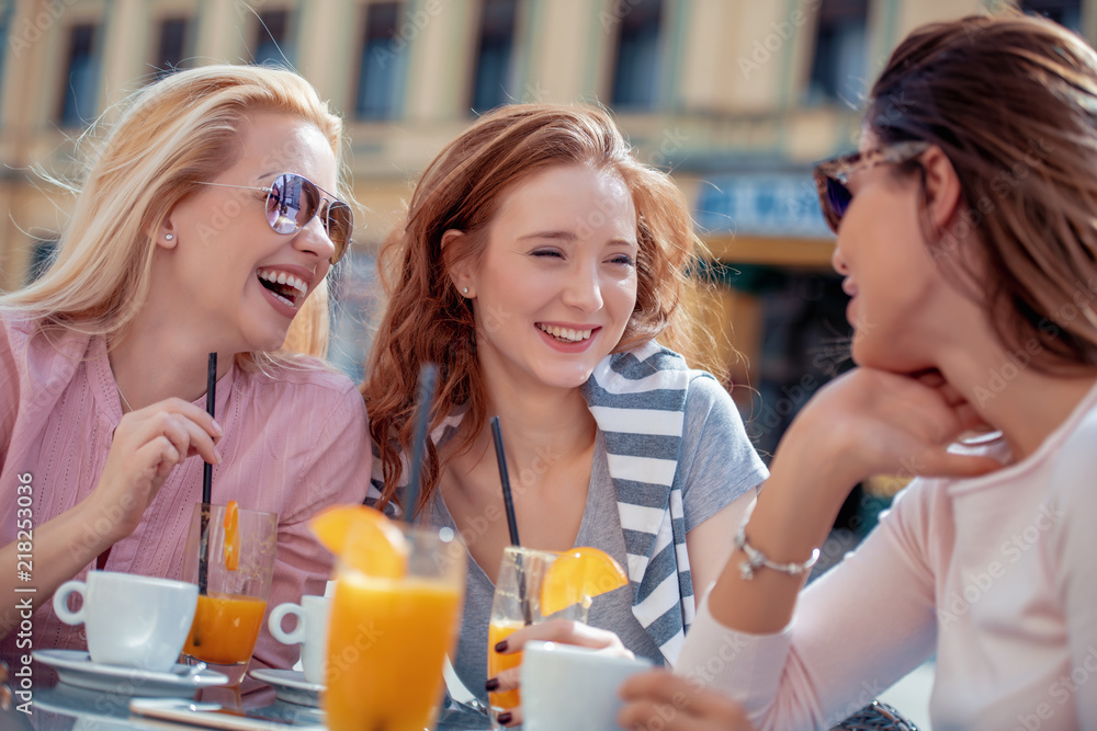 Poster girls having fun in cafe