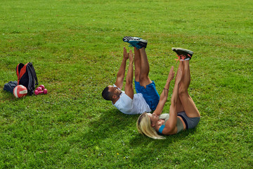 Sports multinational family; wife and husband doing sport exercises together outdoor