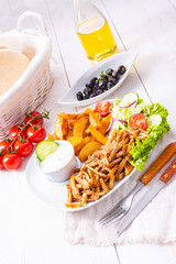 gyros plate it green salad ,olives and potato wedges