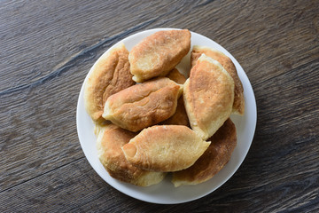 Rustic style. Baked pies on a plate
