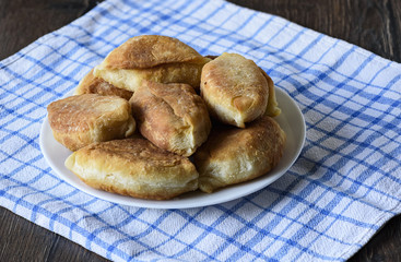 Homemade pies. Baked pies on a plate on a kitchen towel