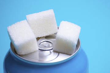 carbonated drink, sugar pieces, tin can
