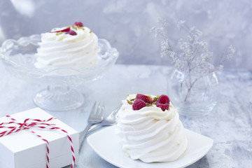 Pavlova cakes with cream and fresh summer berries