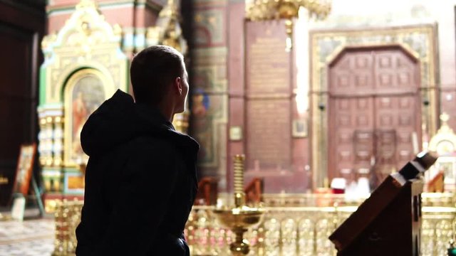 A man looks at the light in the Orthodox Church
