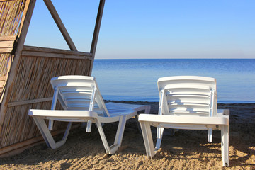two deck chairs on beach, the ashore sea