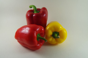Green and red pepper on white background