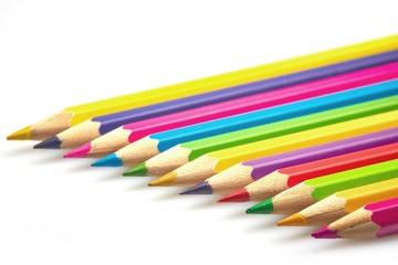 concept-colored pencils laid out on a dark background