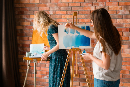 art school classes. creativity painting self expression and artful leisure. girl learning to draw with watercolors on easel.