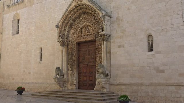 4 K Italy, Puglia region, Altamura, Cathedral of Santa Maria Assunta, gate and sculptures of the main façade. Medieval steps