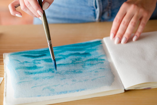 art therapy. painting classes or courses. creativity inspiration expression concept. woman drawing abstract blue painting.