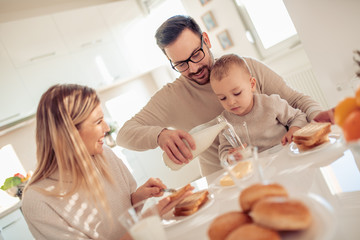 Obraz na płótnie Canvas Family of three having breakfast at home