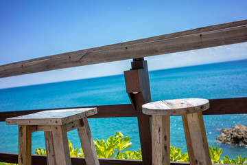 wood chair on beach bar with blue sky ocean view