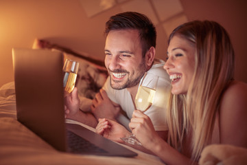 Young couple relaxing in bedroom