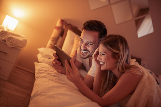 Young Couple Relaxing In Bedroom