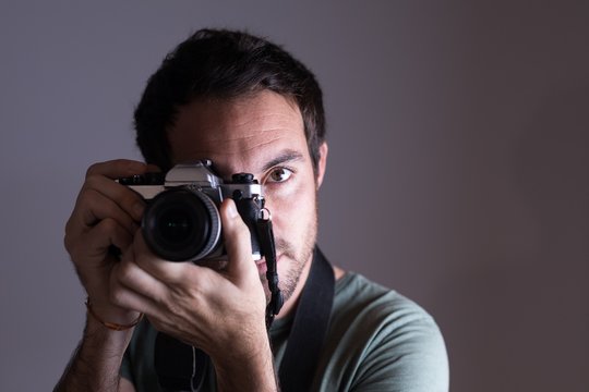 Male photographer clicking photos with camera