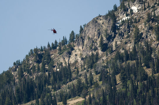 Helicopter Flying Toward the Mountain Ridge