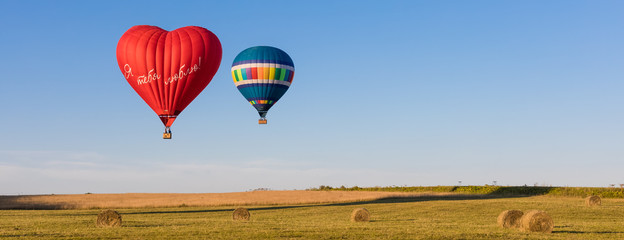 Fototapeta premium Red heart shaped air ballon with inscription in Russian 