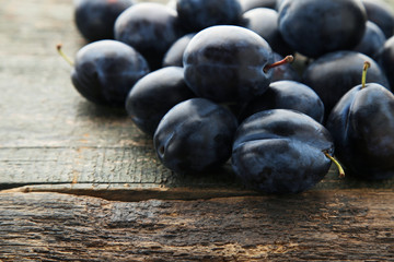 Ripe and sweet plums on wooden table
