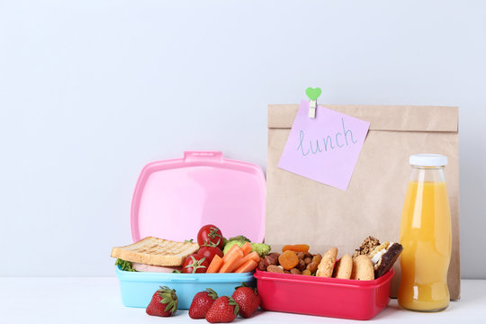 School lunch with paper bag on grey background