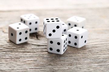 White dice on grey wooden table