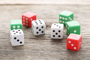 Colourful dice on grey wooden table