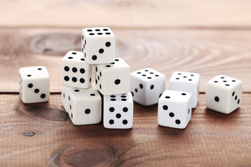 White dice on brown wooden table