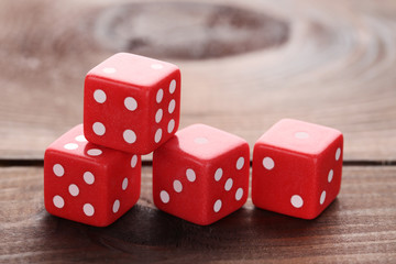 Red dice on brown wooden table