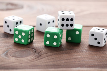 Colourful dice on brown wooden table