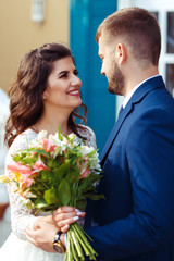 Beautiful Bride and Groom enjoy each other. happy romantic young couple celebrating their marriage. Sexy kissing stylish couple of lovers close up portrait. wedding concept.