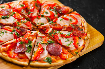 slices of Pizza with Mozzarella cheese, Ham, Tomatoes, salami, pepper, pepperoni Spices and Fresh Basil. Italian pizza
