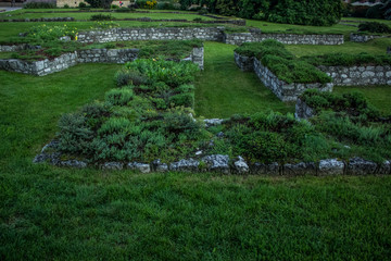 ancient destroyed stones ruins on grass background texture with empty space for copy or text