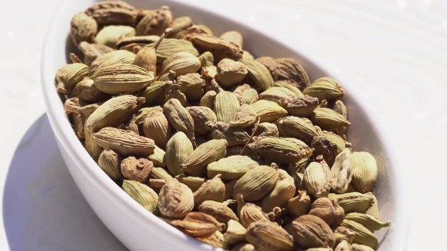Dry spices cardamom on a rotary table. 4K. Macroshooting.