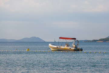Small rubber motor boat, dinghy in morning light