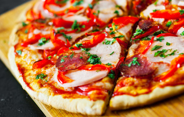 slices of Pizza with Mozzarella cheese, Ham, Tomatoes, salami, pepper, pepperoni Spices and Fresh Basil. Italian pizza