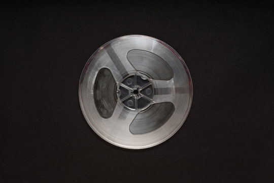 Spinning reel of tape recorder on black background