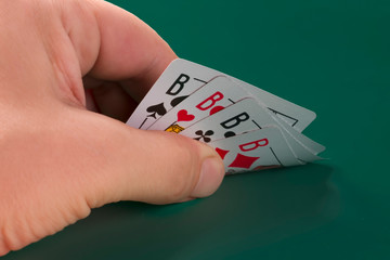playing cards in hand, a combination of quads