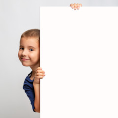 White billboard with smiling child on the side