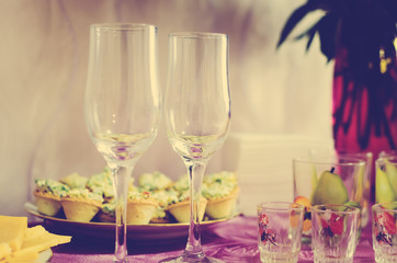 Empty glass wine glasses for drinks stand on the table. Tinting in the style of instagram.