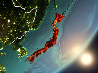 Sun rising above Japan from space