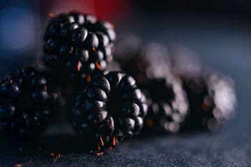 Fresh blackberries, close-ups on a dark background.