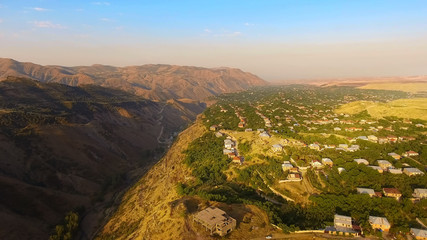 Amazing mountain valley and old Armenian village on sunny day, aerial view