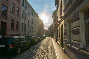 street with old houses in rostock - backlight scene